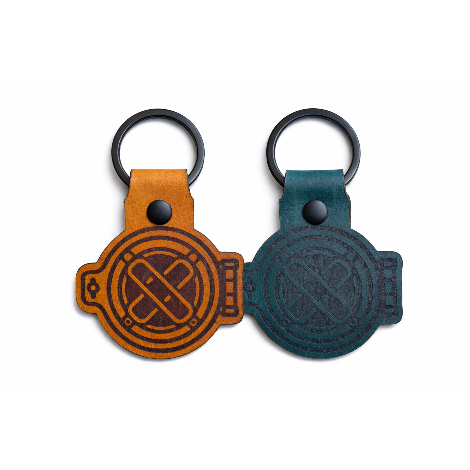 Two leather keychains, one brown and one blue, featuring 15 Fathoms helmet logos on a white background.
