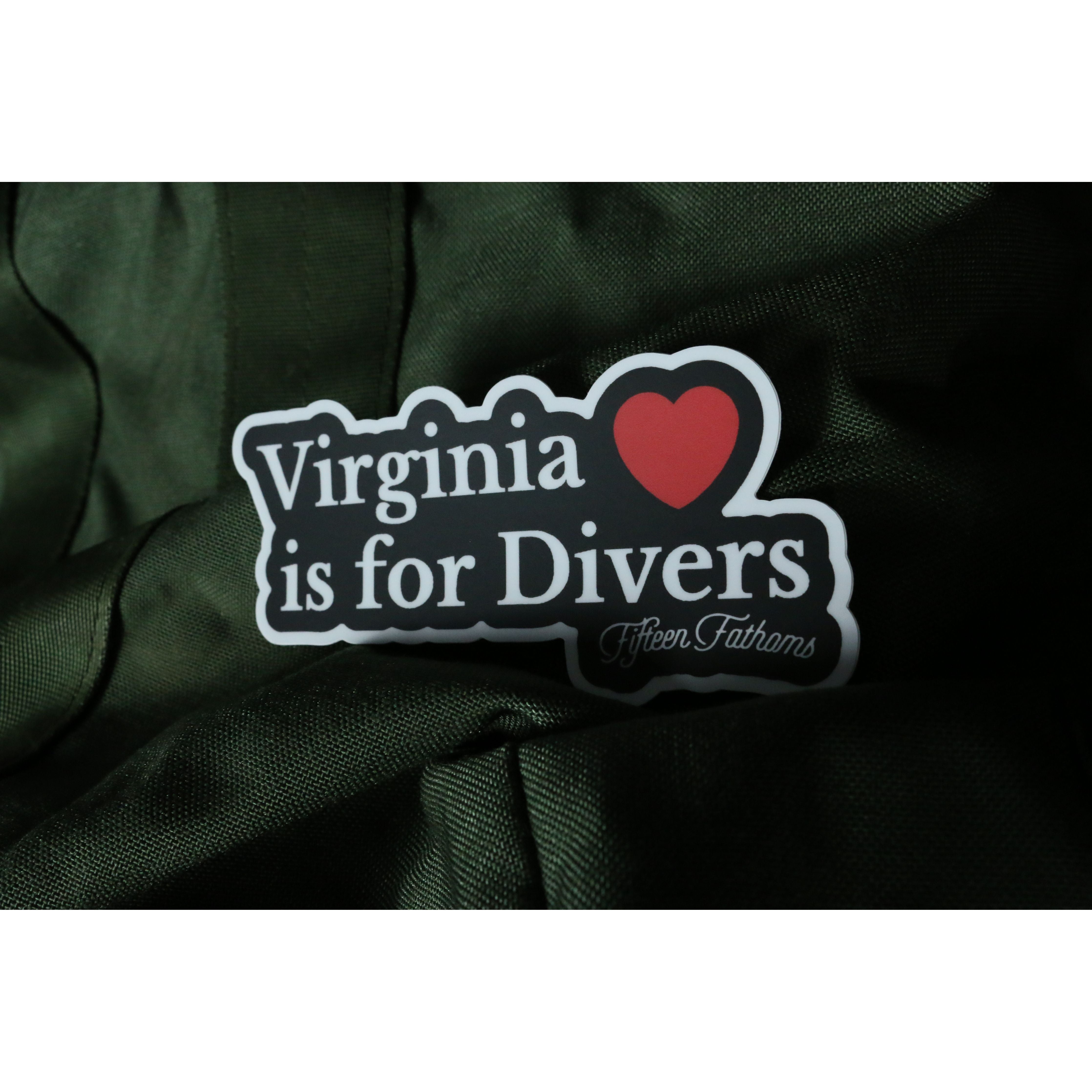 Virginia is for Divers Sticker resting on dark green fabric