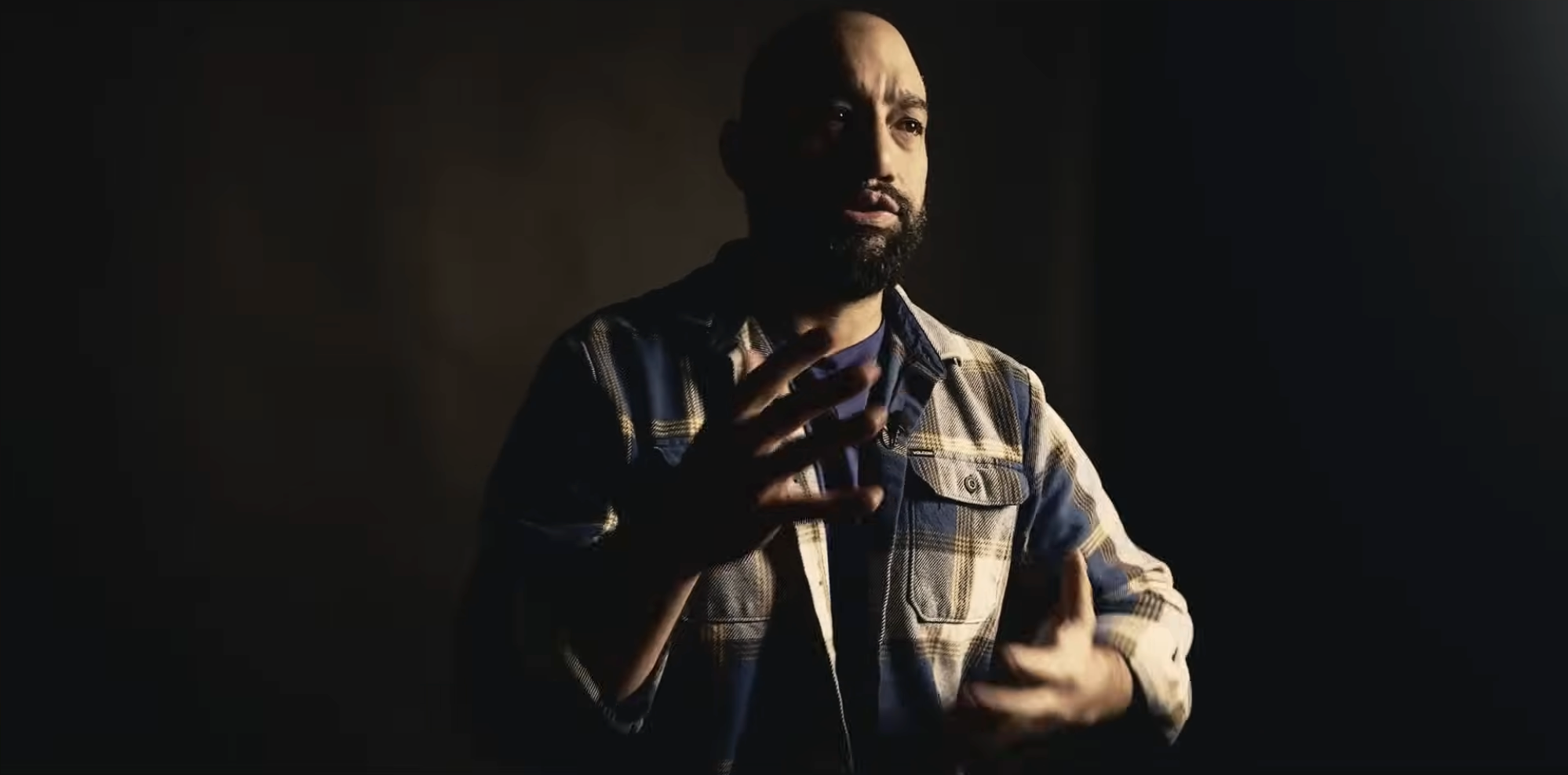 Tommy McConnell speaking and using hand gestures mid-interview.
