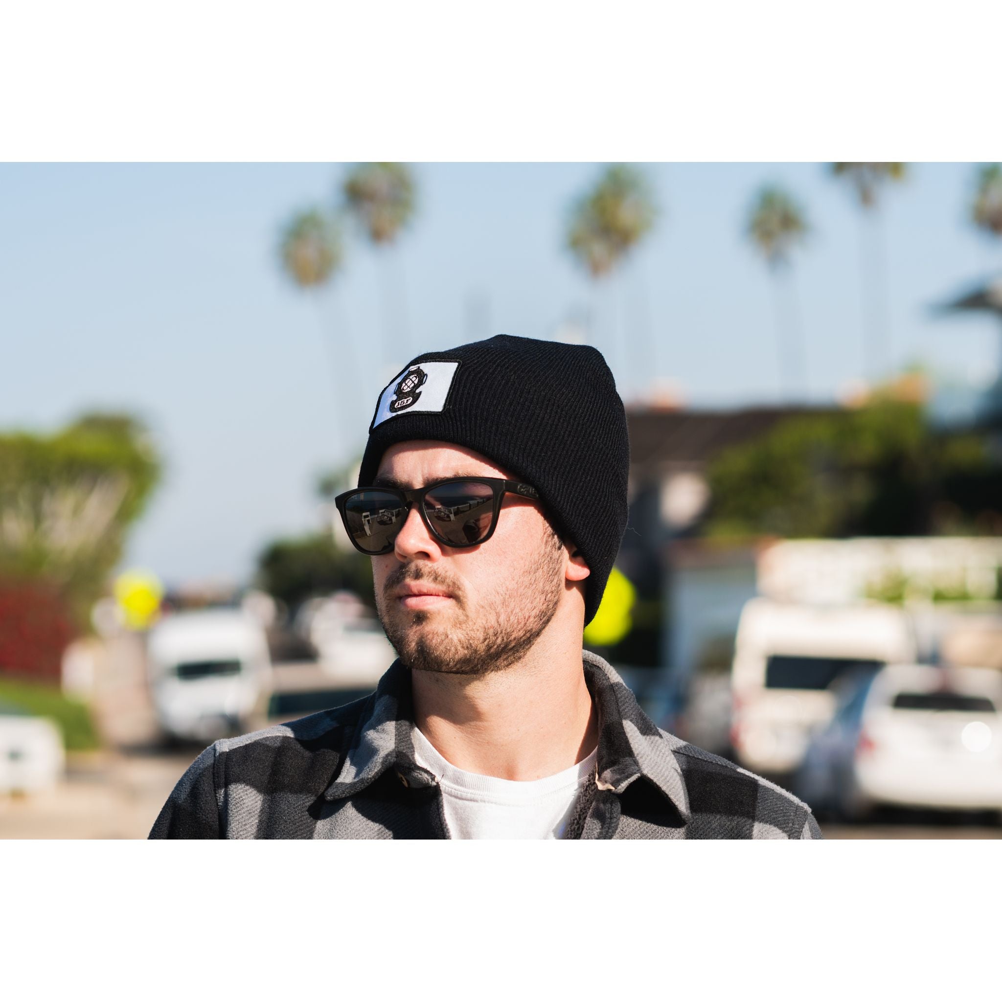 The Watch Cap - man wearing black beanie on a sunny day
