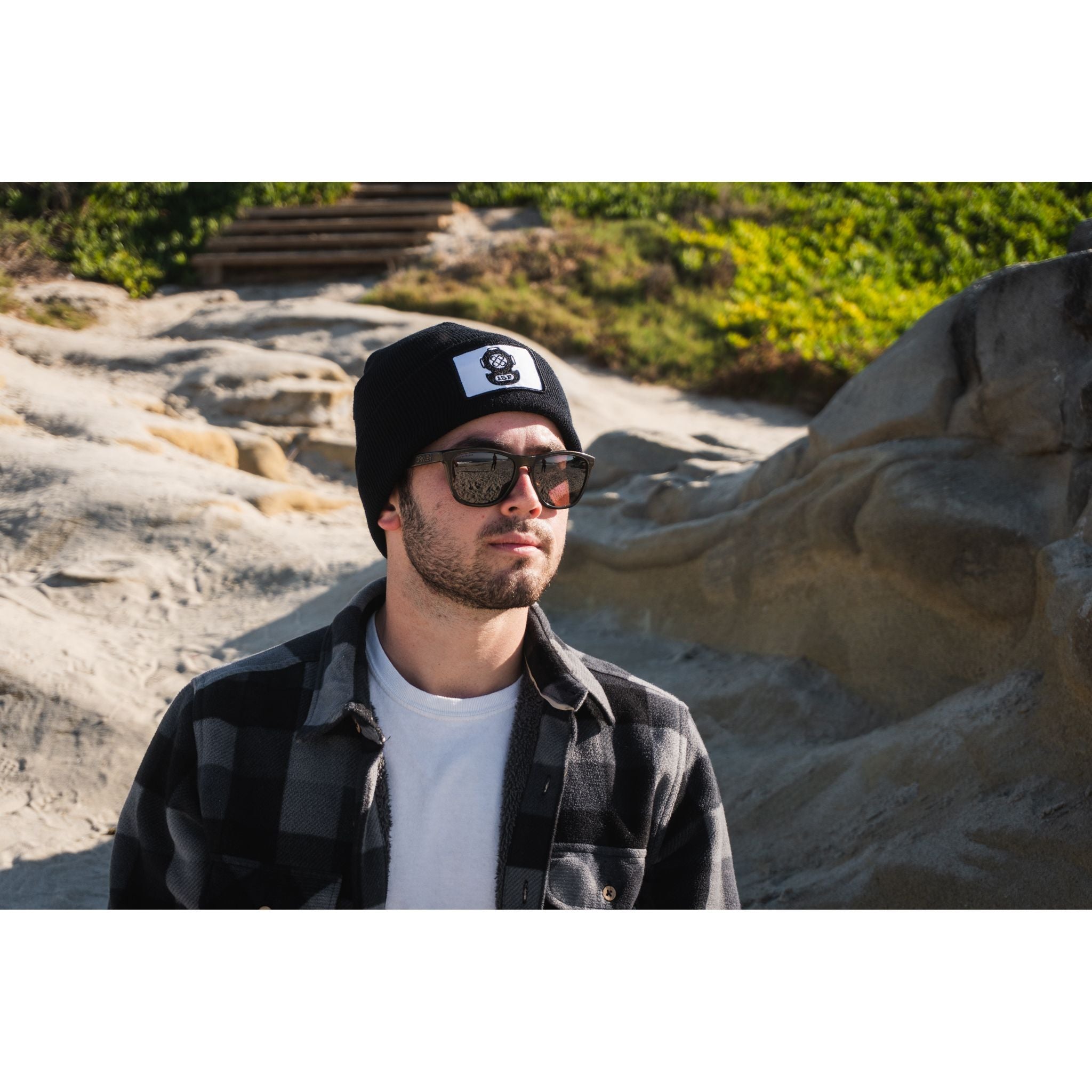 The Watch Cap - man wearing black beanie outside on a sunny day