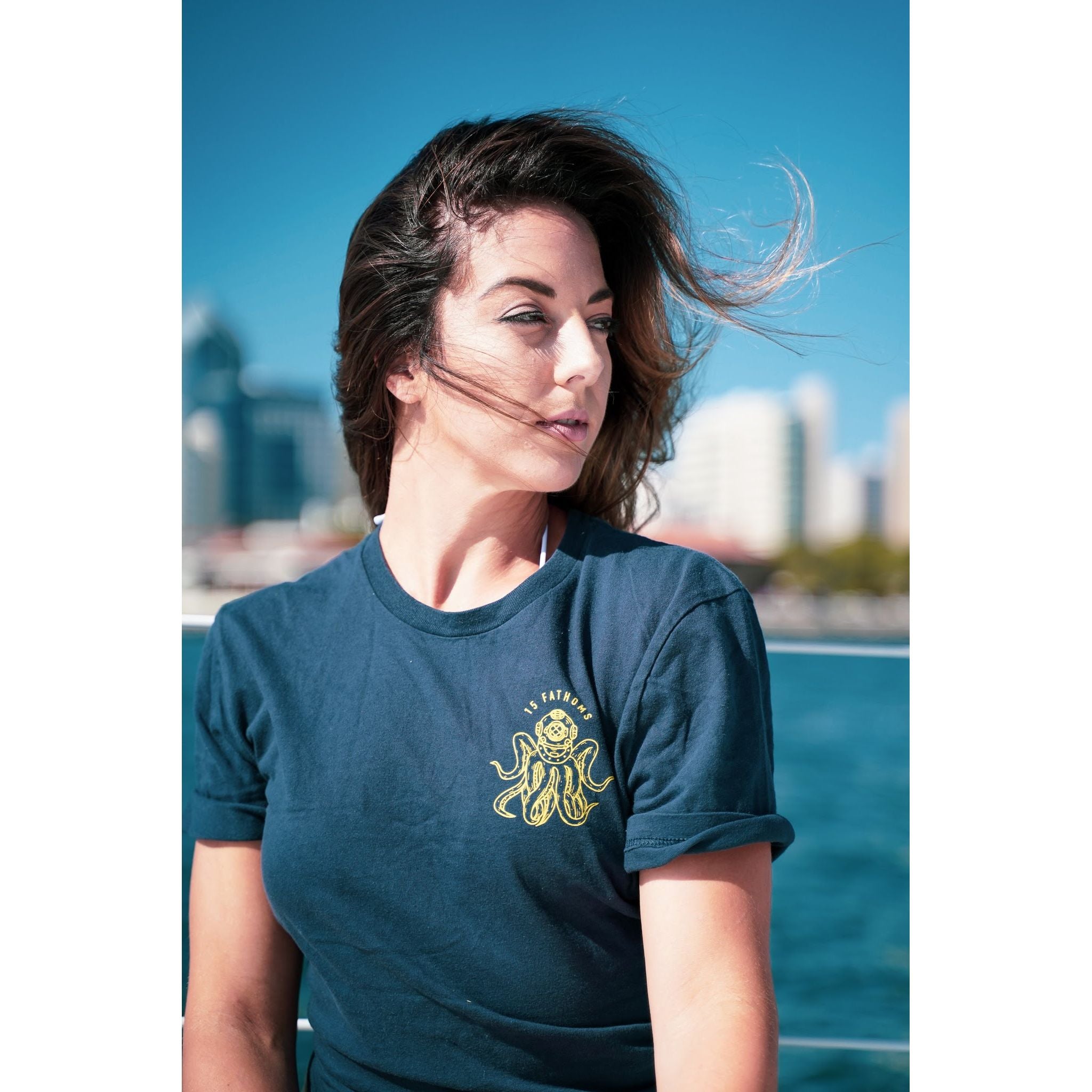 Dive Bar - woman wearing t-shirt featuring dive helmet with tentacles logo on the heart front