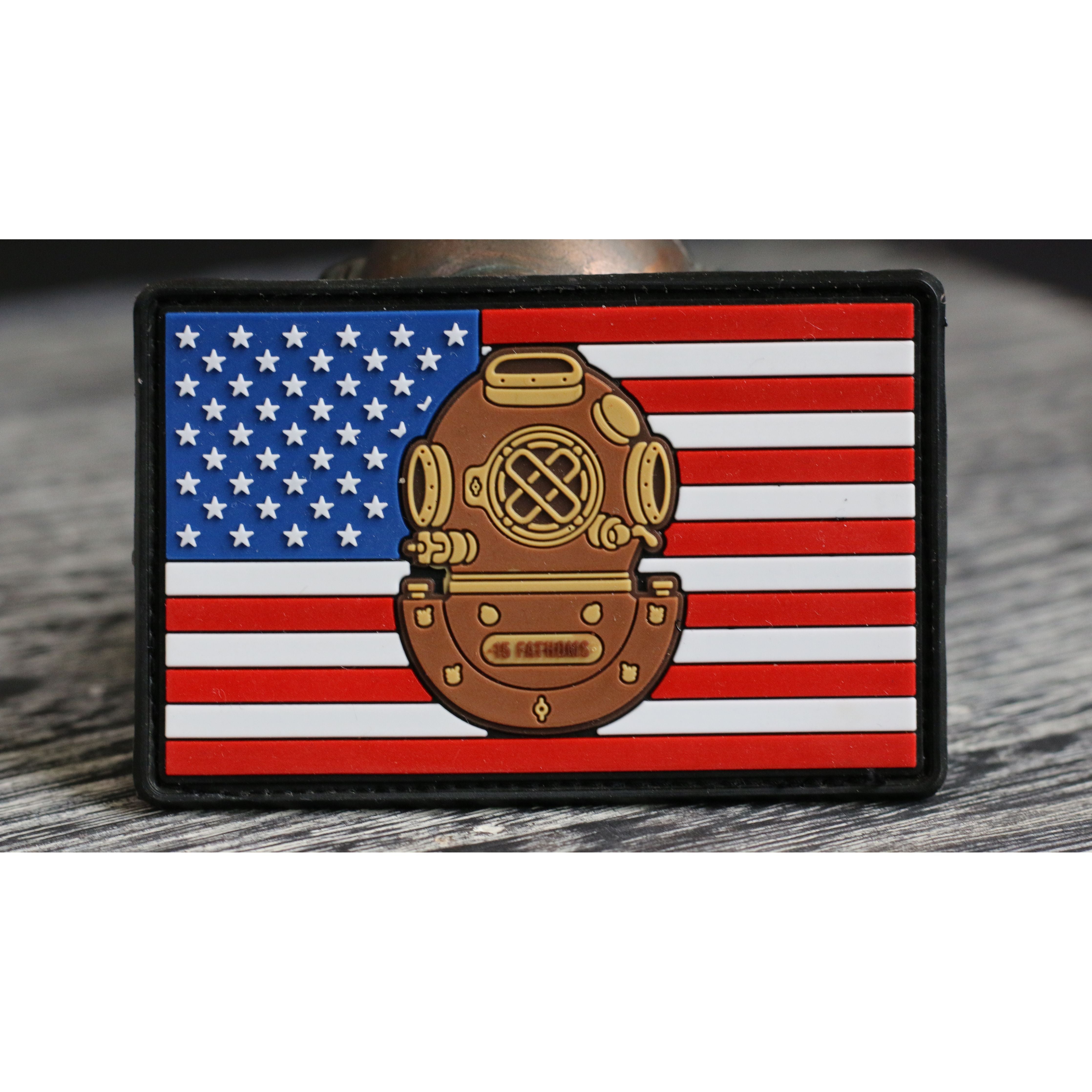 American flag Mark-5 Patch - dive helmet with “15 Fathoms” text on base of helmet with american flag background on display