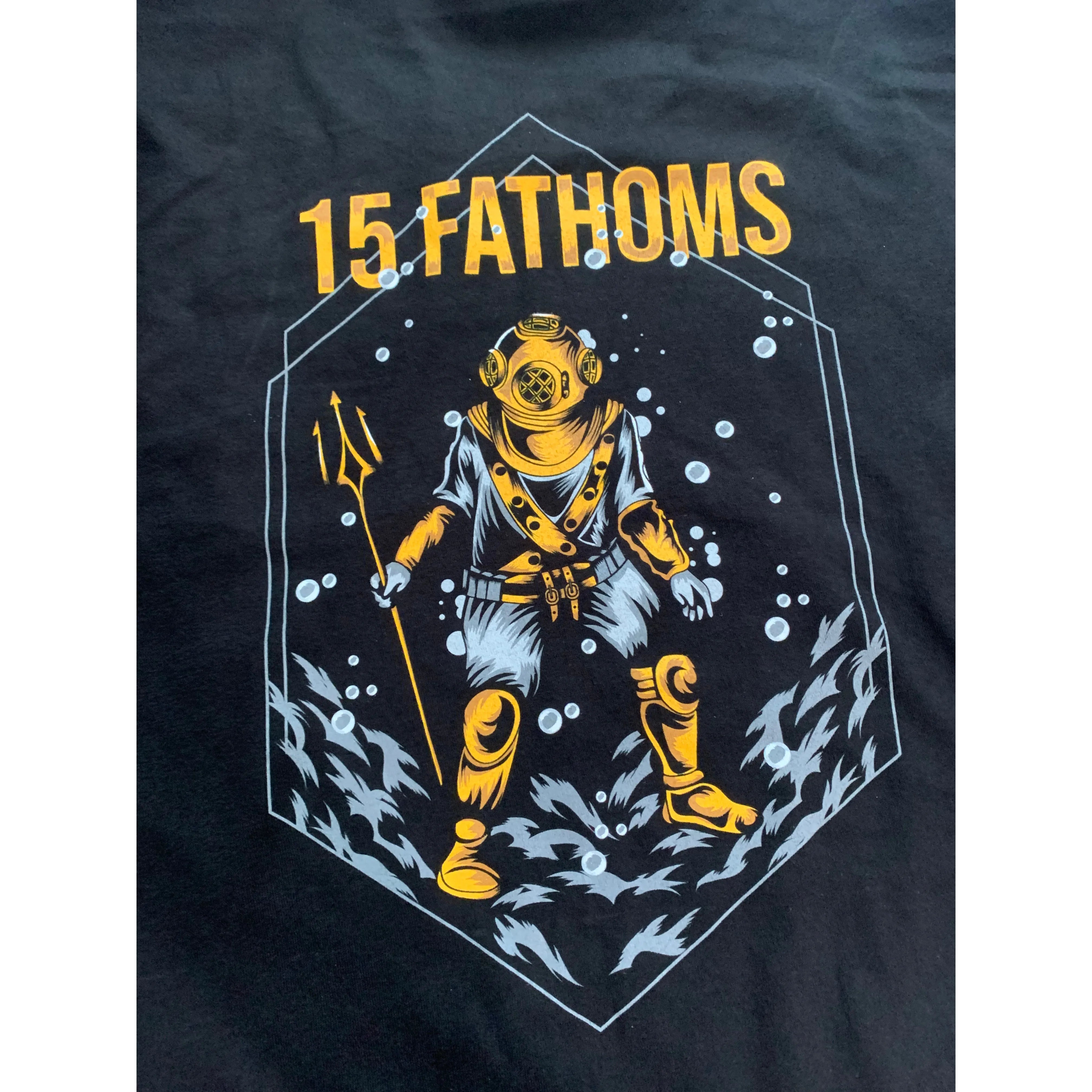 Trident Diver - close up of image of diver holding a trident with “15 Fathoms” text above