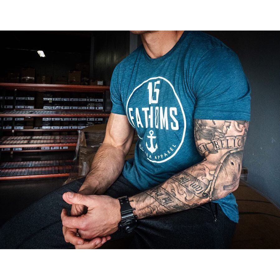 Classic White Logo - muscular man wearing teal t-shirt with white 15 Fathoms logo on front