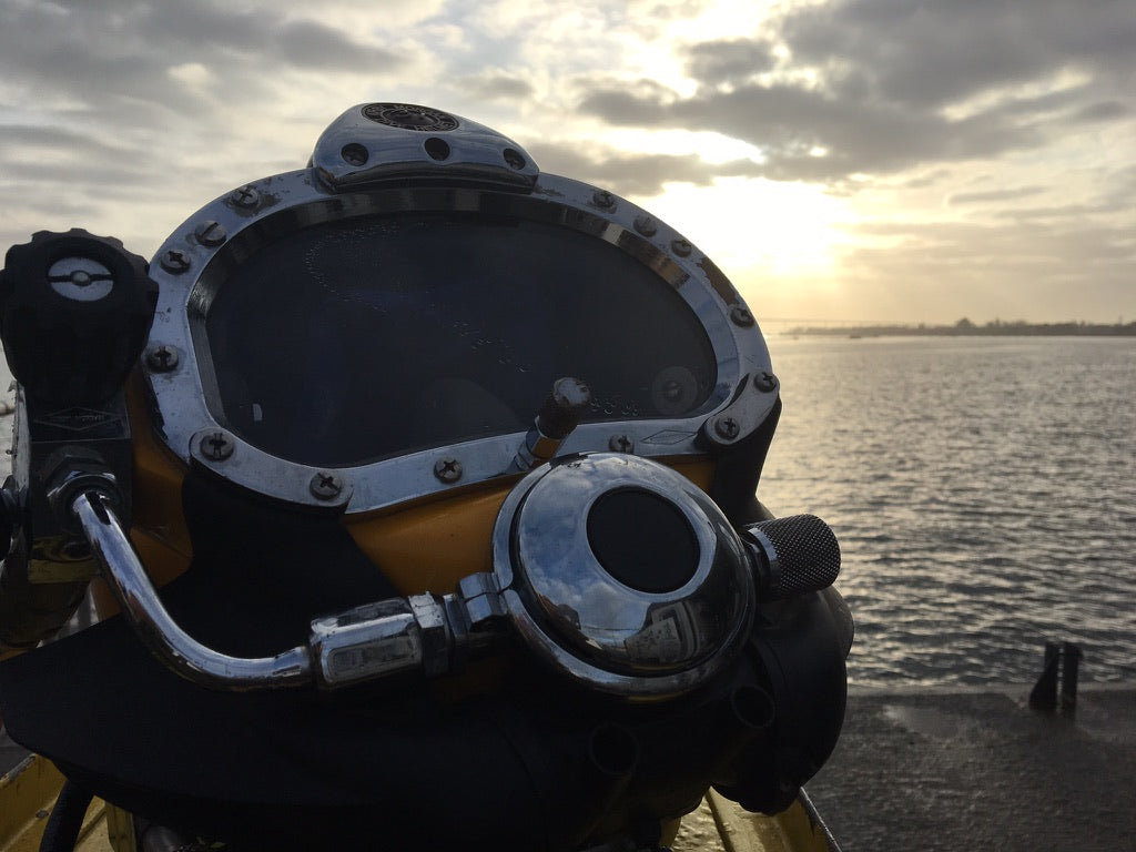 Commercial diving helmet resting in front of the sunset