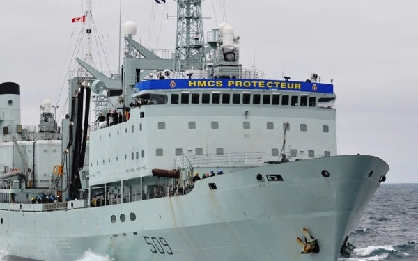 Large naval ship named 'HMCS Protecteur' on a body of water.