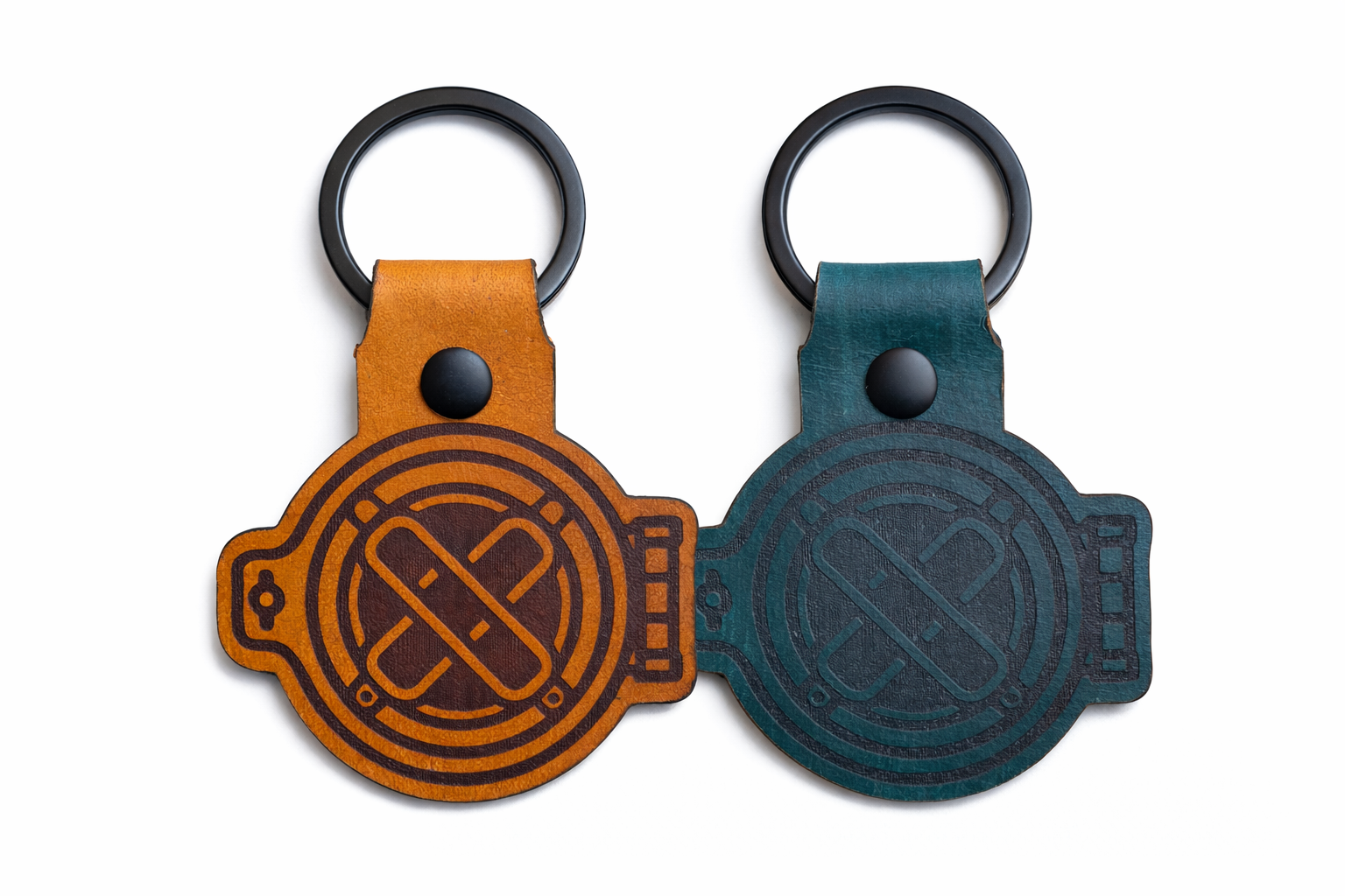 Two leather keychains, one brown and one blue, featuring 15 Fathoms helmet logos on a white background.