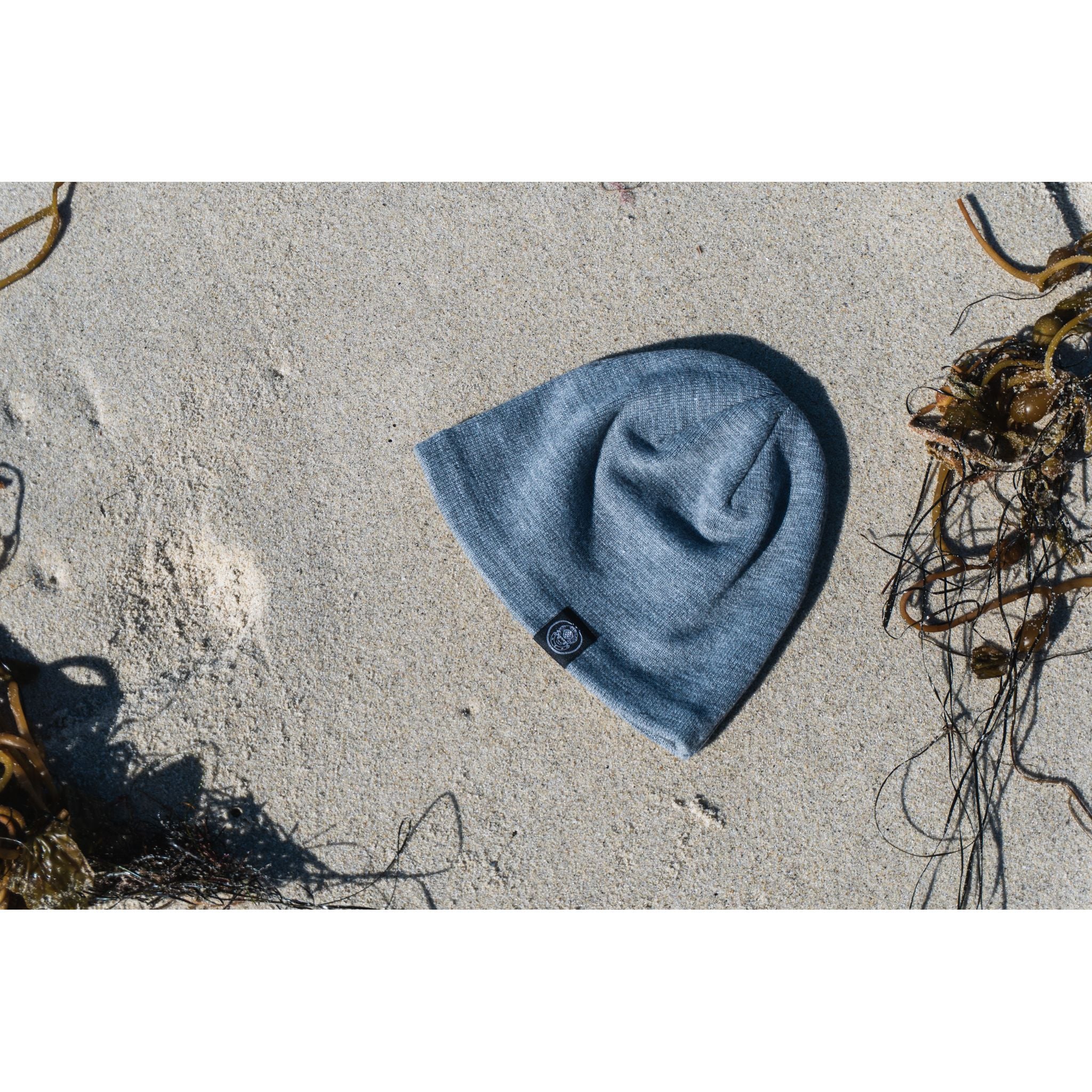 Sport Beanie - gray beanie displayed on a sandy beach