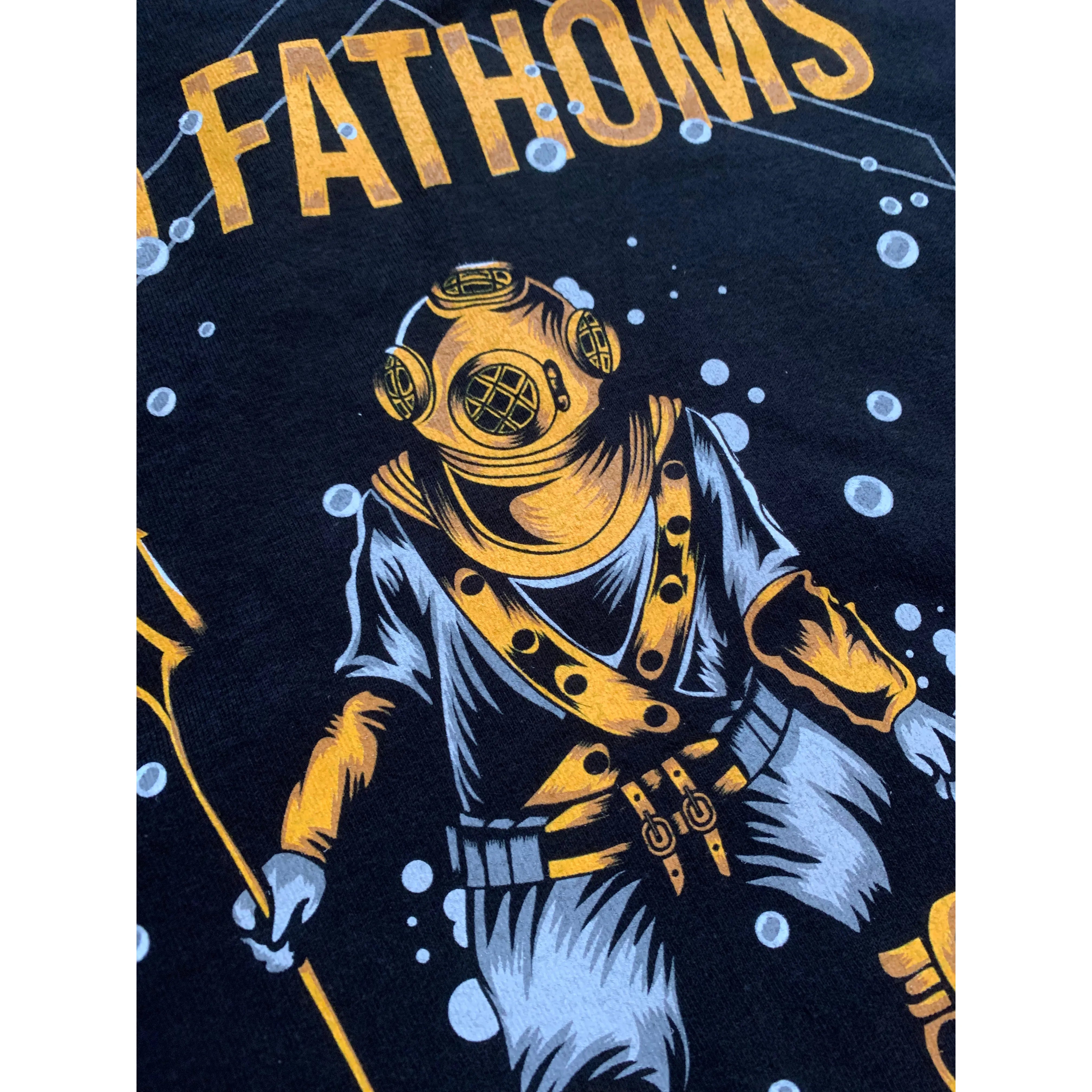 Trident Diver - close up image of diver holding a trident with “15 Fathoms” text above