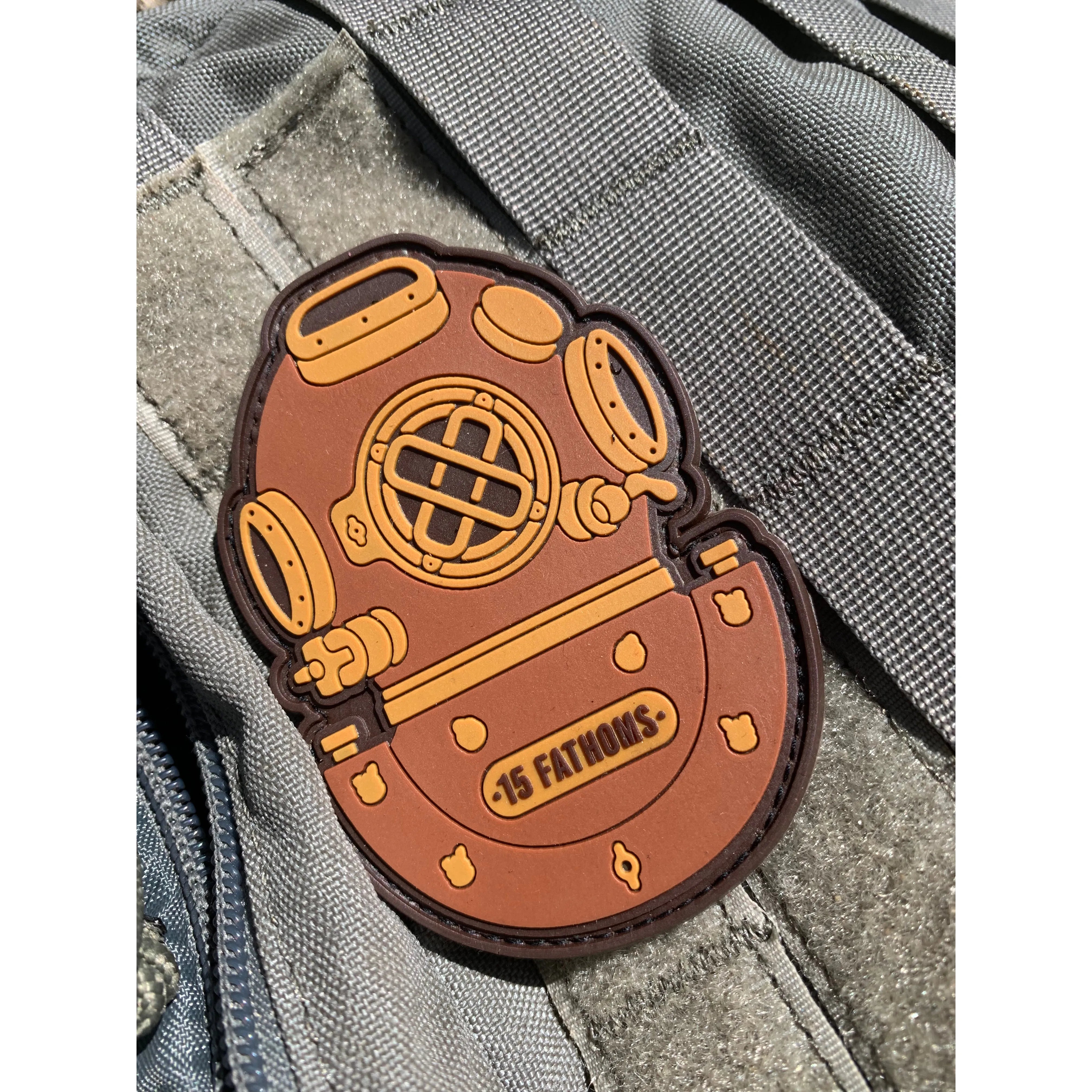 Mark-5 Patch - dive helmet with “15 Fathoms” text on base of helmet, made from PVC with velcro backing placed on velcro surface